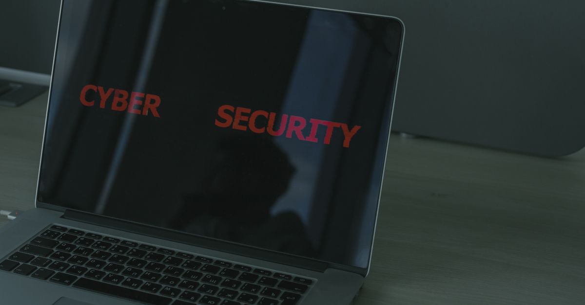 Close-up of a laptop displaying cybersecurity text, emphasizing digital security themes.