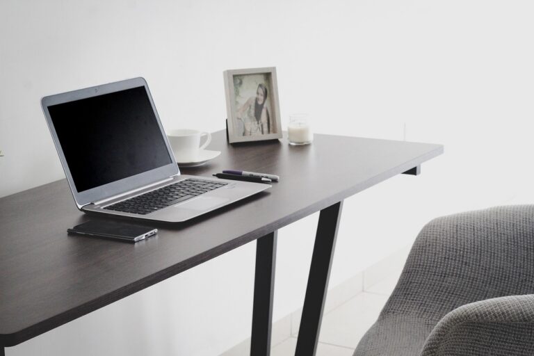 Home office workspace with laptop representing remote work and digital workplace tools for distributed teams in 2026