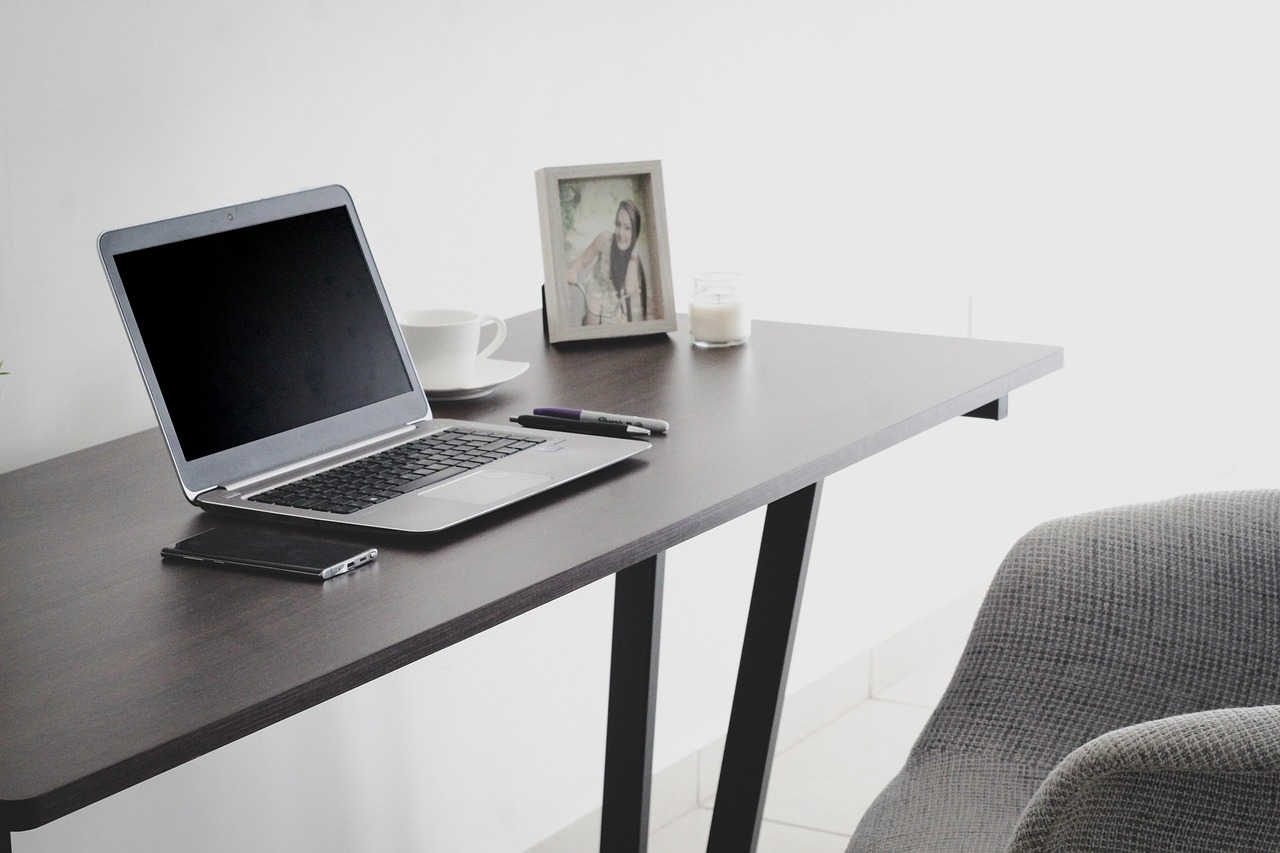Home office workspace with laptop representing remote work and digital workplace tools for distributed teams in 2026