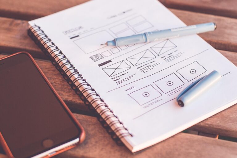 Web design workspace with plans and sketches representing digital design trends for small businesses in 2026