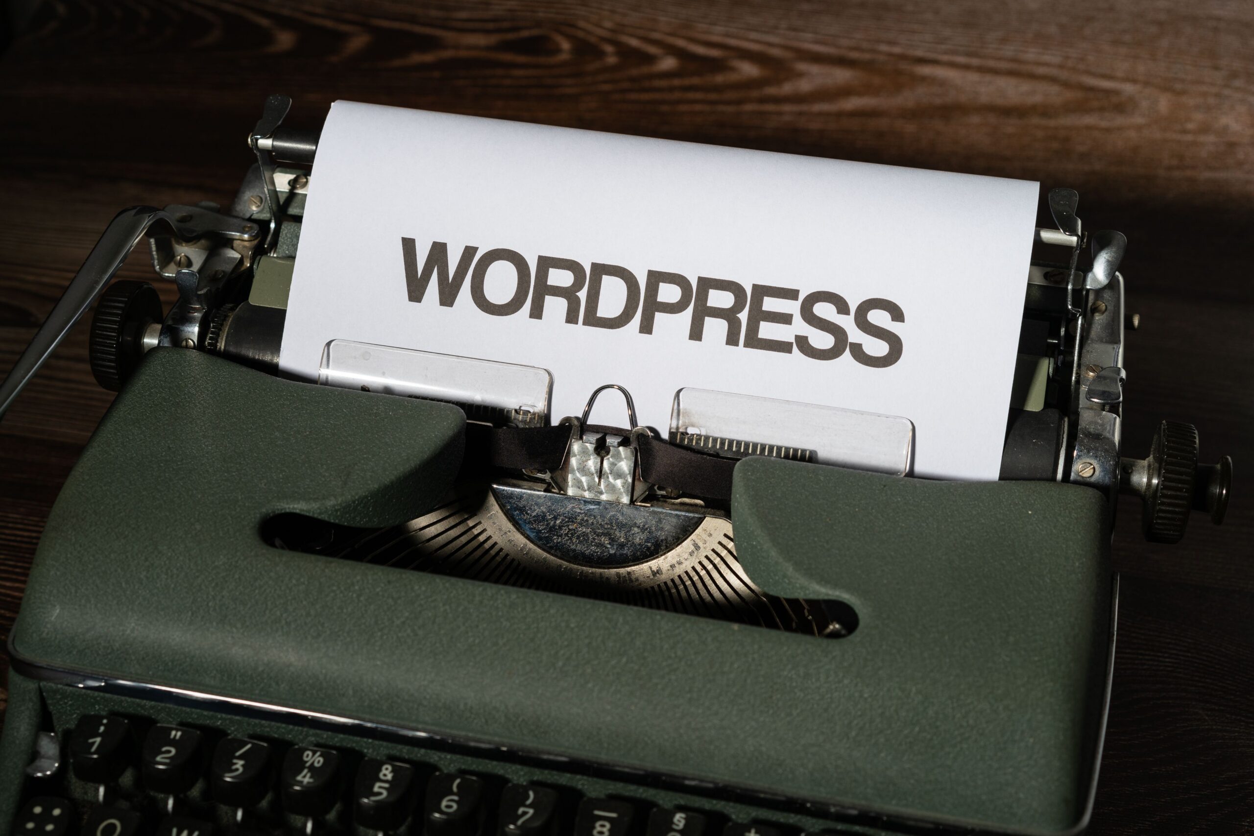 Vintage typewriter with WordPress typed on paper representing WordPress website maintenance