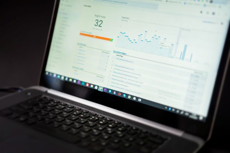 Laptop displaying a website analytics dashboard with charts for small business tracking