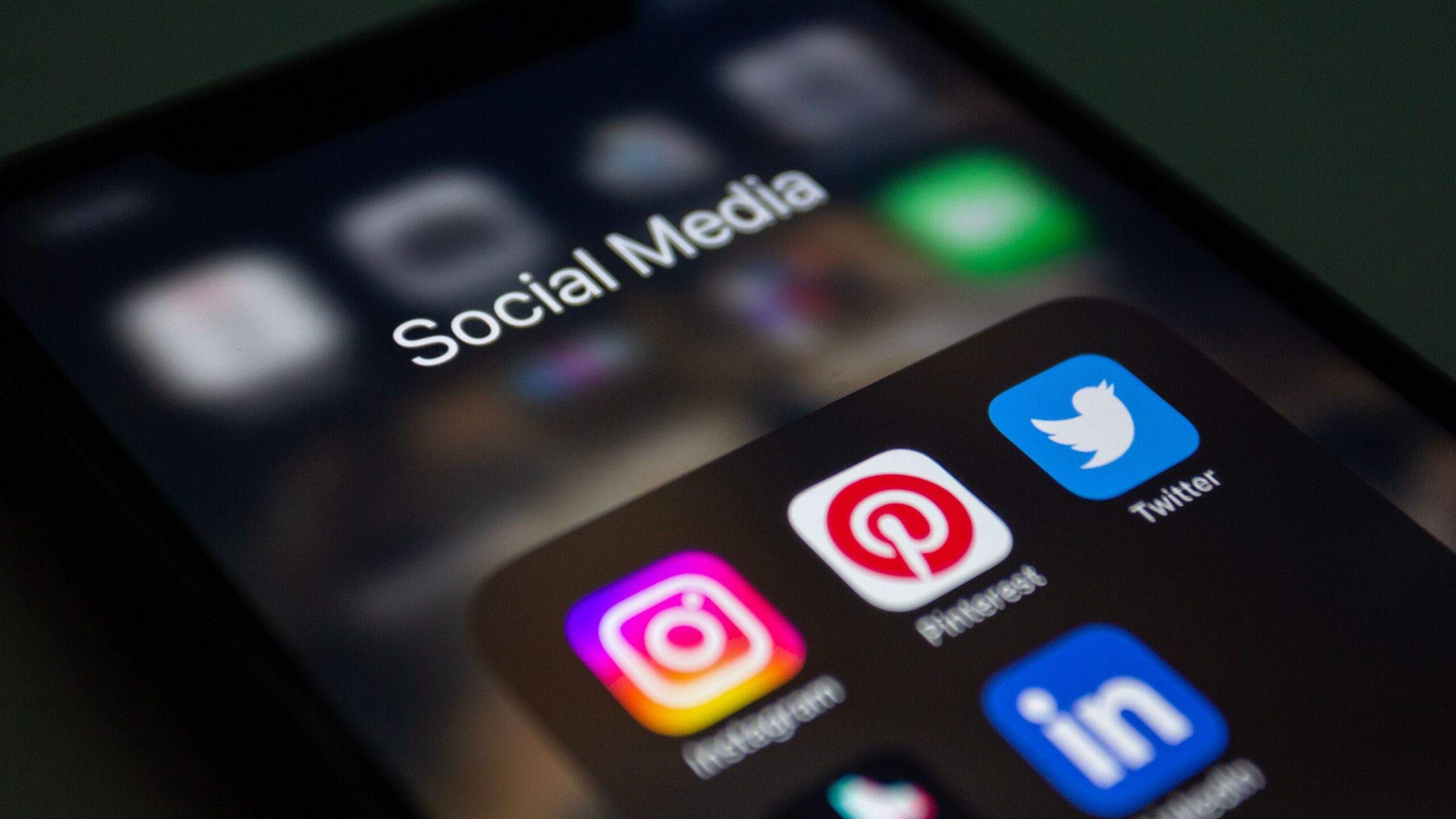 Smartphone showing popular social media apps for advertising a small business
