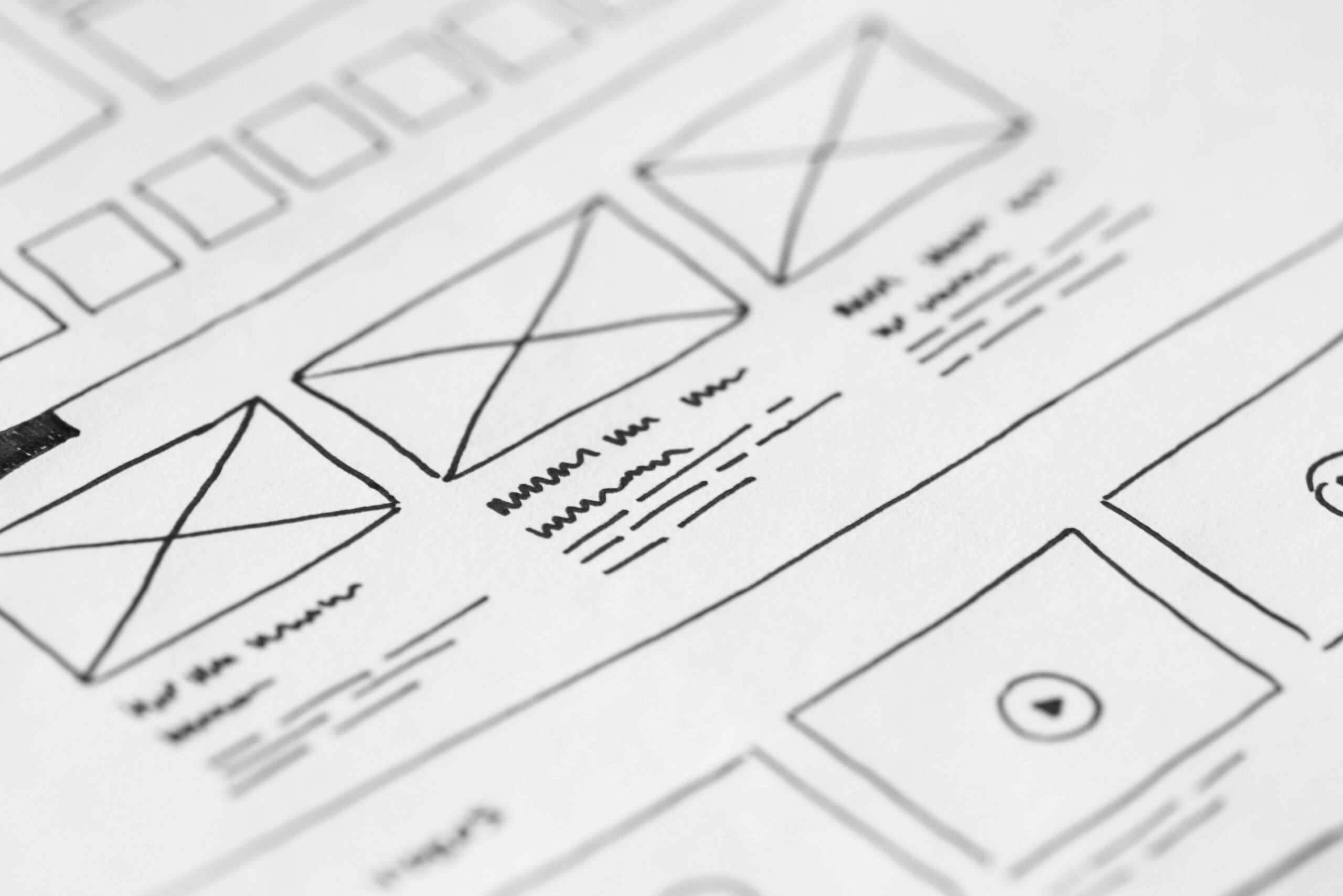 Hand-drawn website wireframe design on paper for a UX project