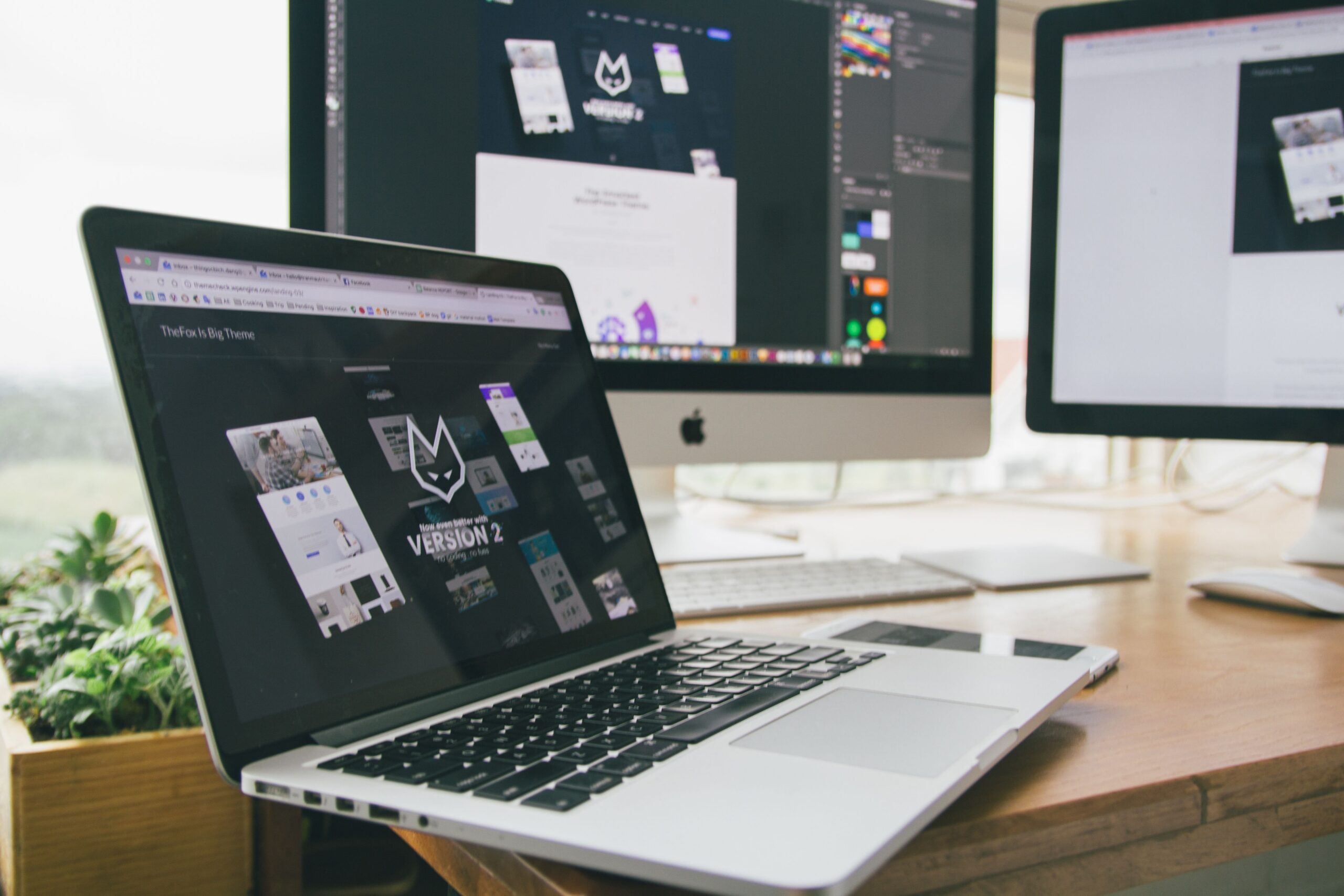 How much does a website cost - designer workspace with laptop and monitors