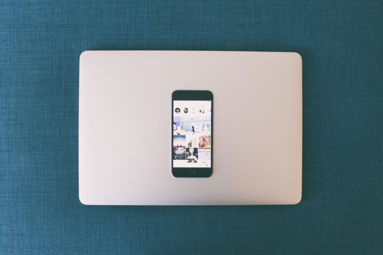 Social media marketing for small business: flat lay of smartphone and laptop showing social media apps