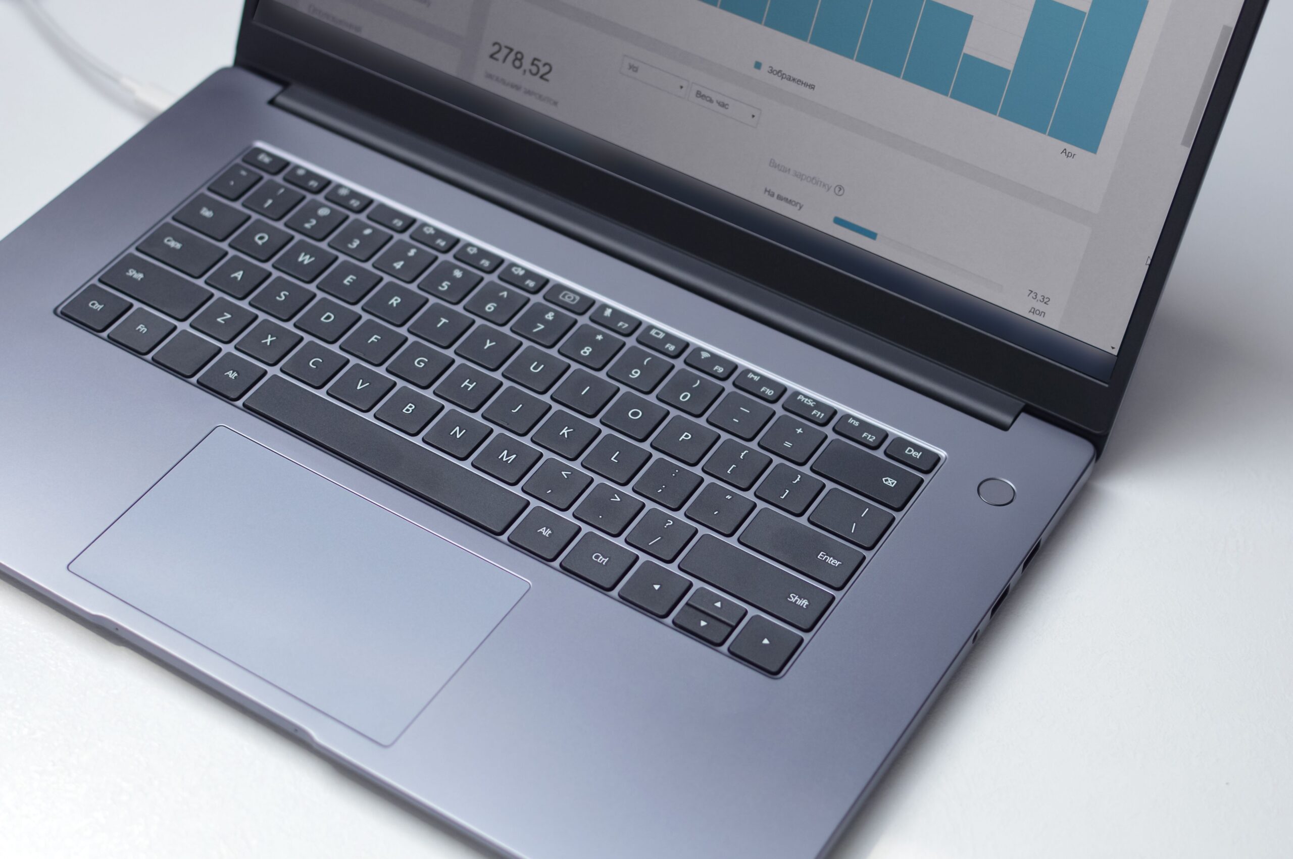 CRM customer relationship management dashboard on a laptop screen in a modern office