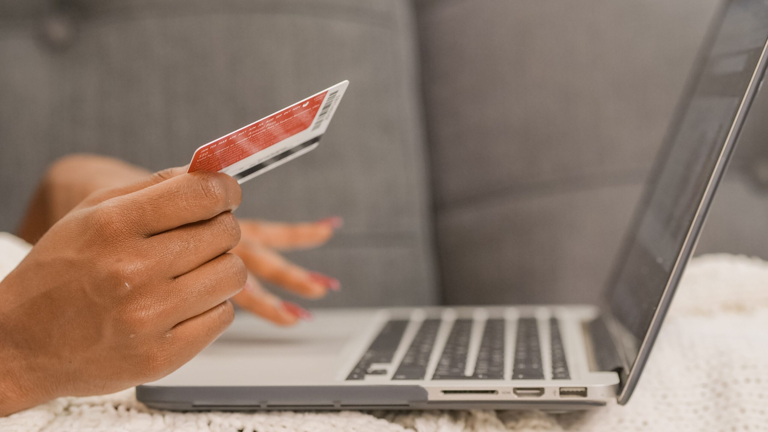 Person using a credit card for online shopping on a laptop representing e-commerce conversion optimization