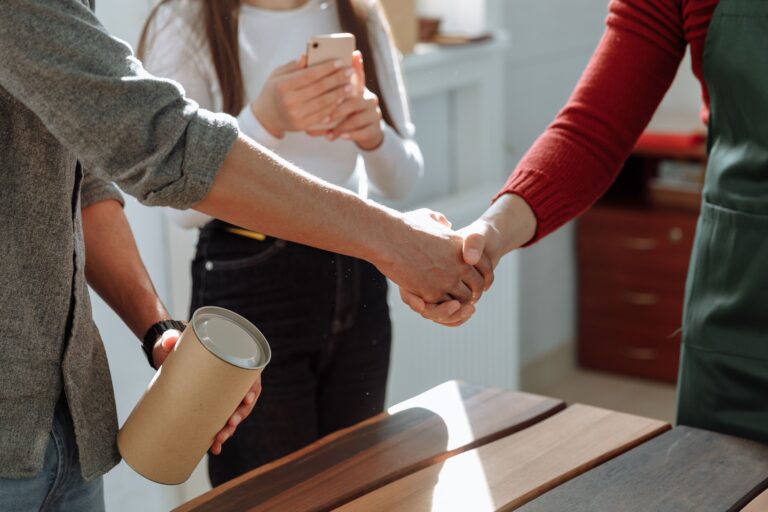 Businesspeople shaking hands, representing long-term customer relationships and retention