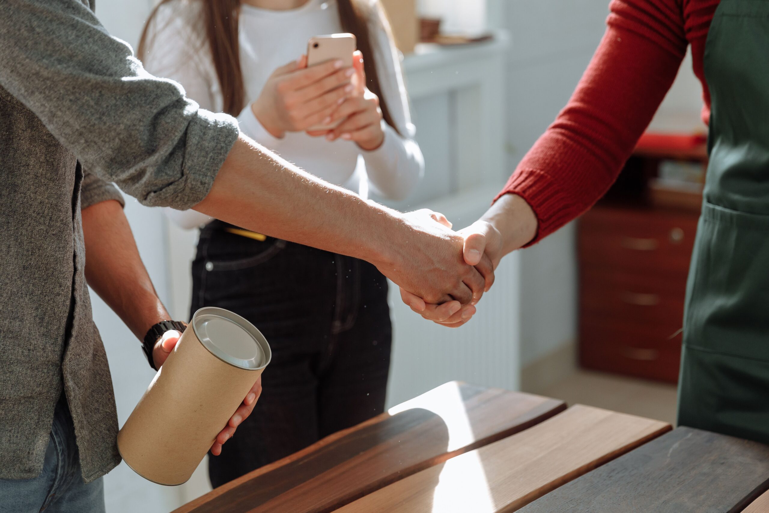 Businesspeople shaking hands, representing long-term customer relationships and retention