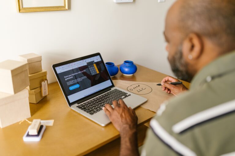 Small business website guide - entrepreneur planning business on a laptop