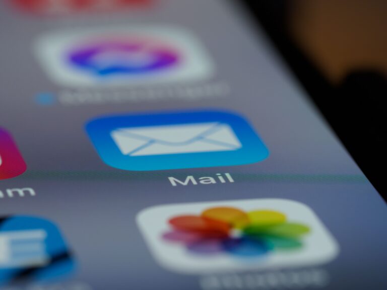 Email app icon on a smartphone showing inbox management for business email deliverability