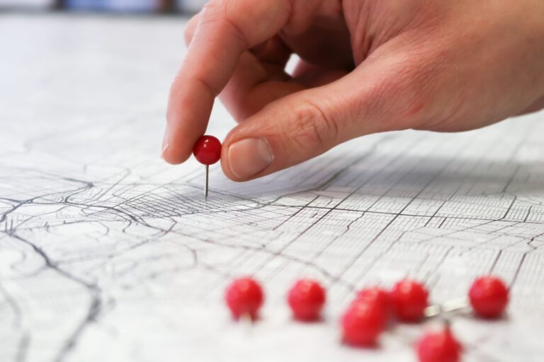 Hand placing a location pin on a map, representing local SEO for small business near-me searches