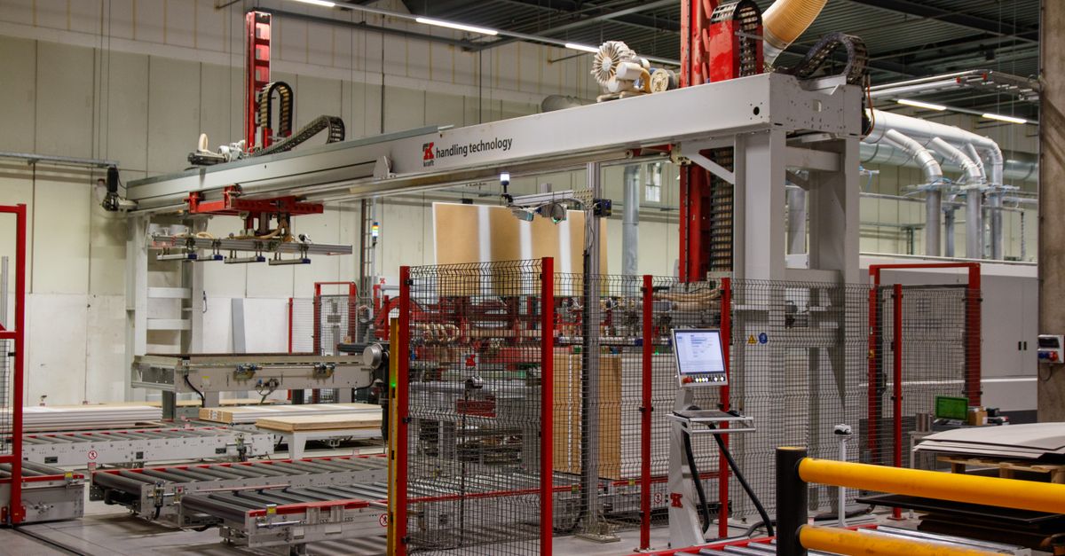 Industrial machinery with robotic arm in a modern manufacturing facility.